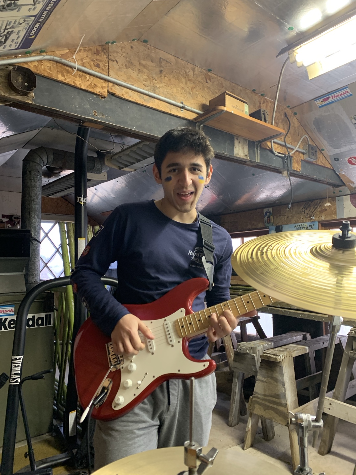 Ethan playing a red guitar