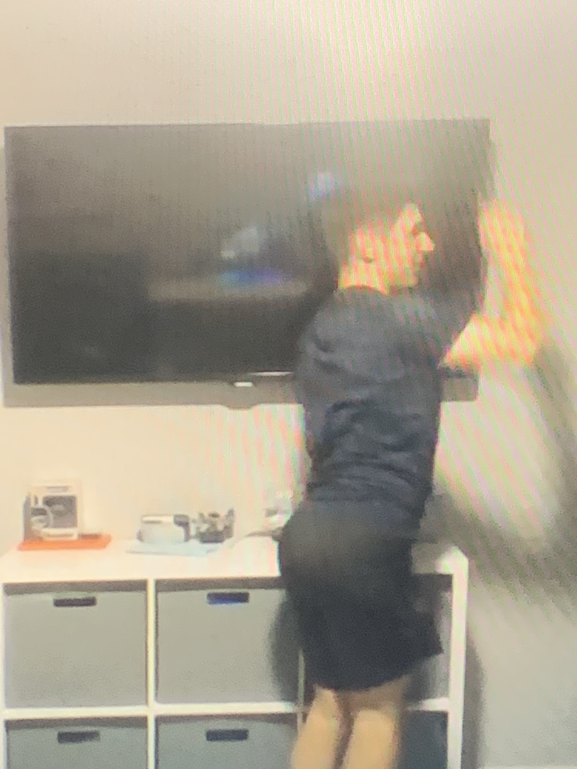 Ethan reaching toward a television
